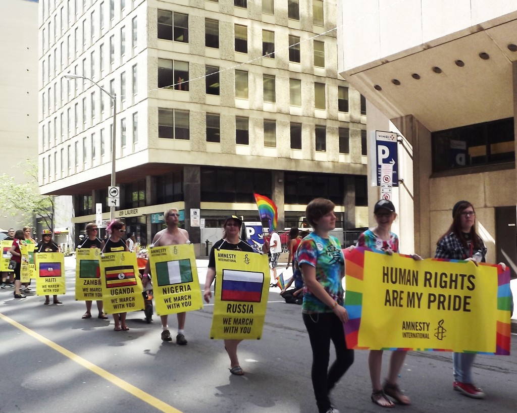 Amnesty International representatives march at the Pride 2014 parade in Ottawa, Canada. Photo Credit © Nicole Rutherford