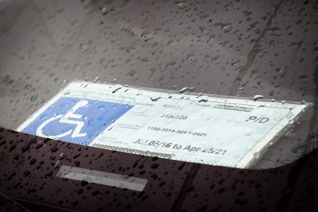 An accessible parking permit sits on the dashboard of a car parked at the Walmart Train Yards Supercentre in Ottawa.
