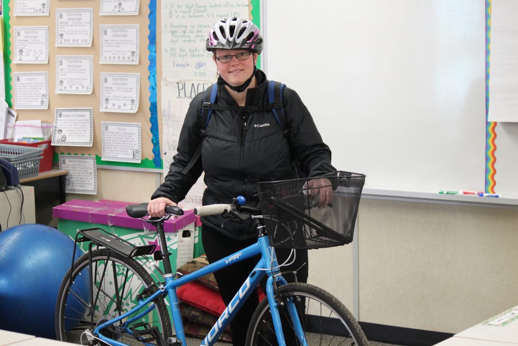 Jennifer Dunlop has committed to cycling to work as often as she can. Here, she stands in her classroom with her bike.